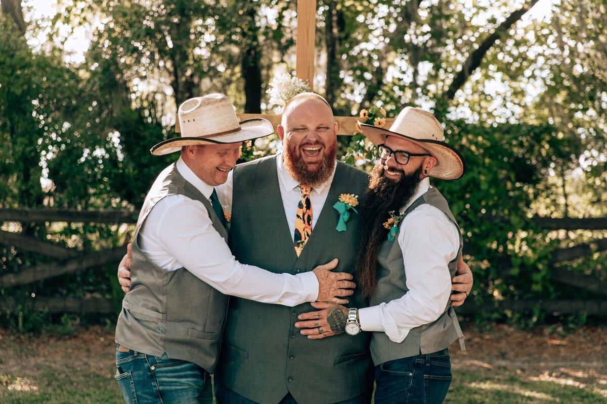 groom and his groomsmen laugh during photos
