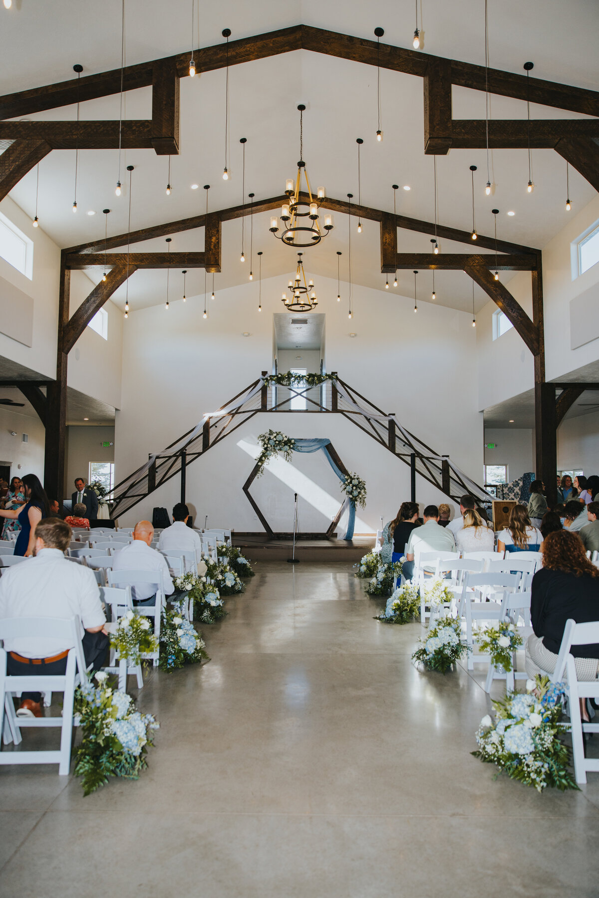 Indoor ceremony in the grand hall, with the staircase at the front
