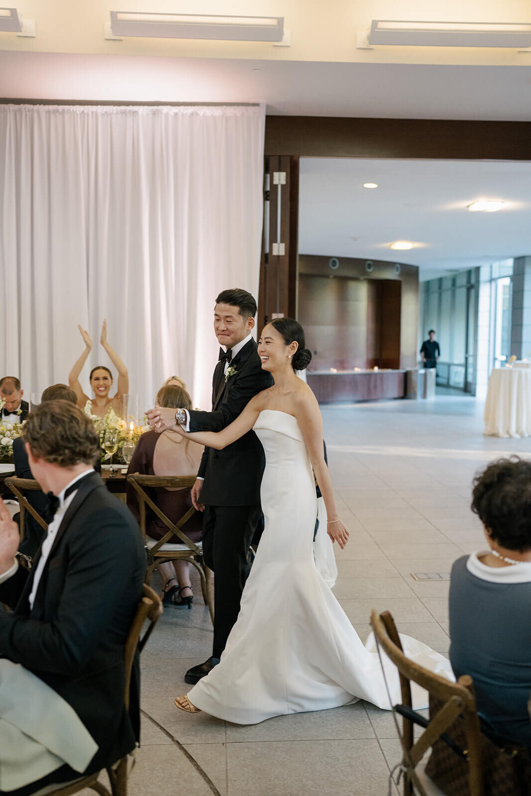 Bride and groom make their grand entrance into the reception room at their Aspen Meadows Resort wedding.