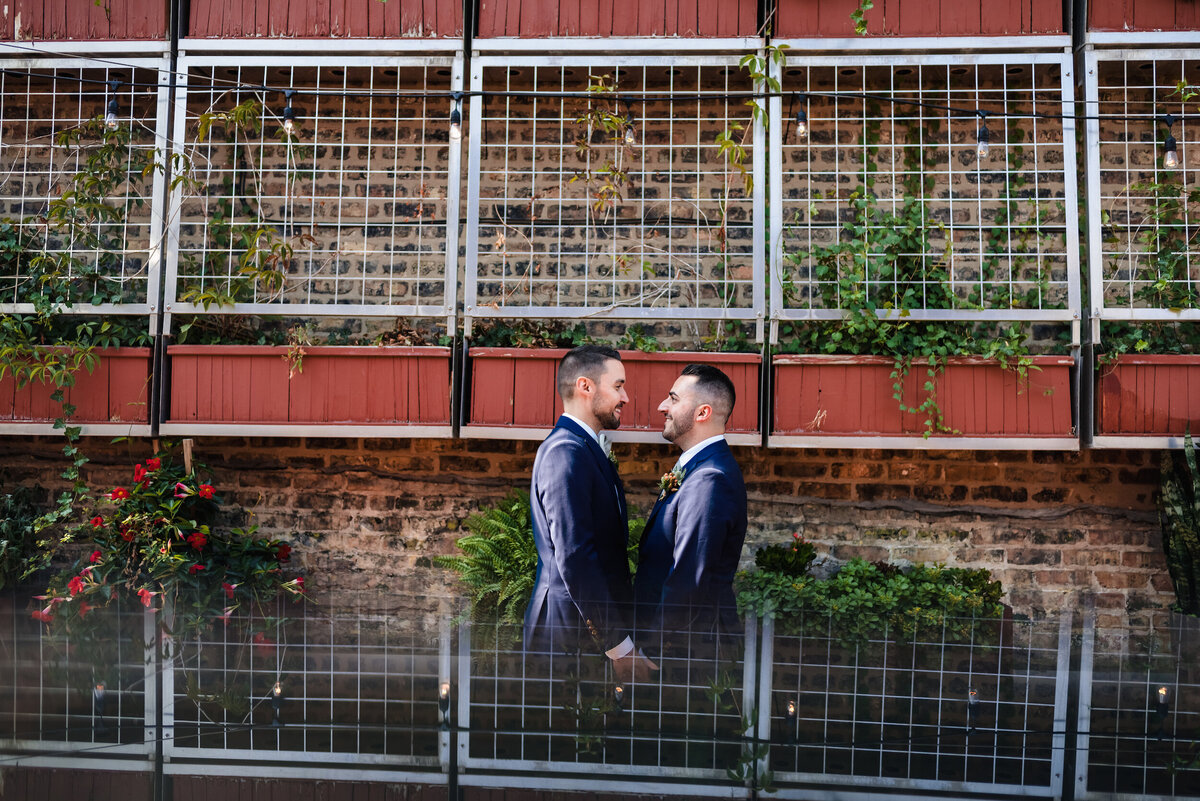 an LGBTQ couple stand s in the gard at the Homestead on the Roof in Chicago, IL