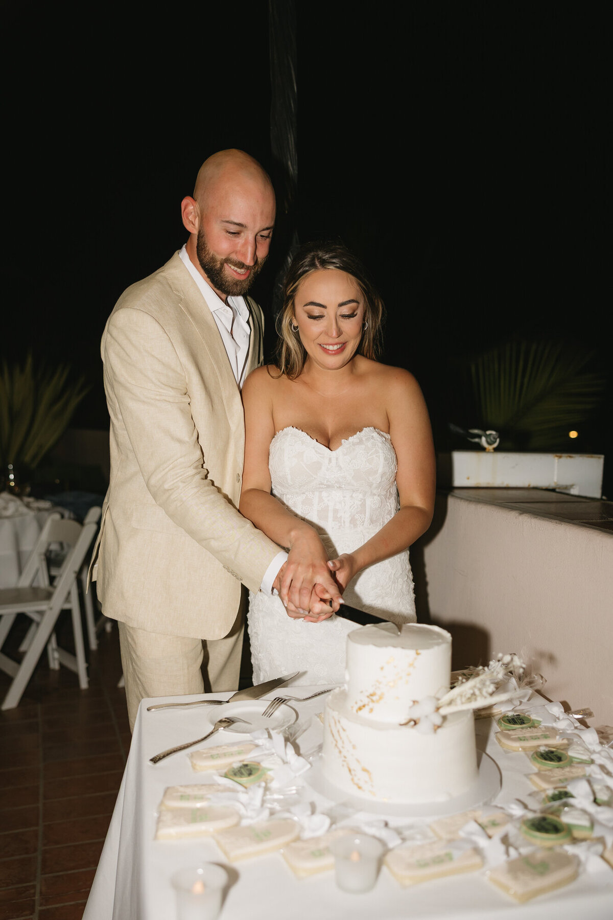 Bride and groom cutting wedding cake during reception at Hilton Beachfront Resort Santa Barbara