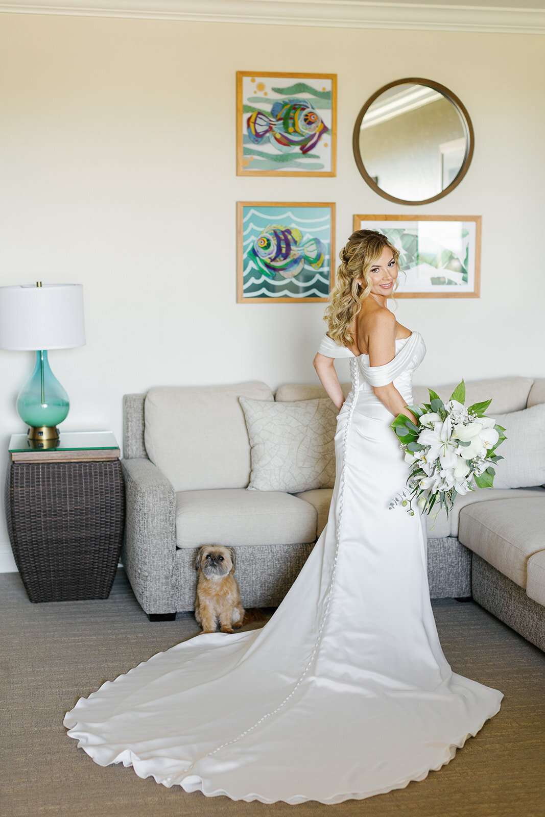  Monica poses in her wedding gown alongside her dog, a heartfelt moment captured before saying ‘I do’ in the Florida Keys.