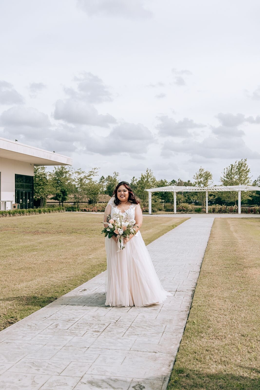 bride walking down the aisle at the center of deltona