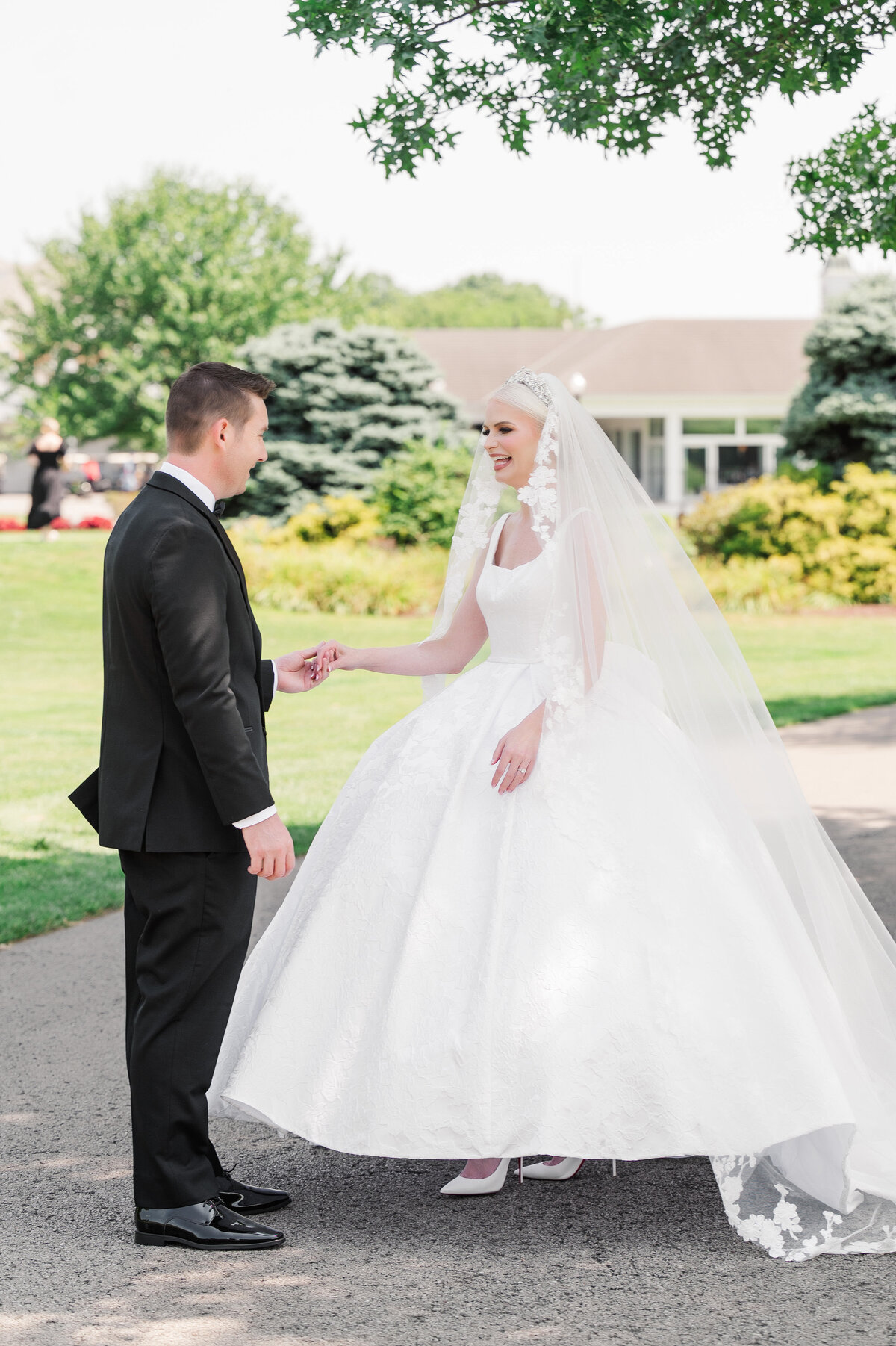 wedding picture of a bride and groom seeing each other for the first time on the golf course at The Grand Resort