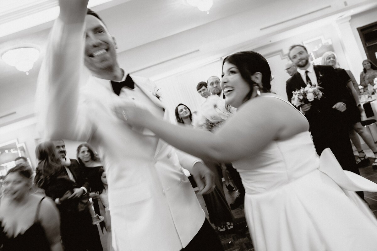 bride and groom full of energy as the first enter their reception space
