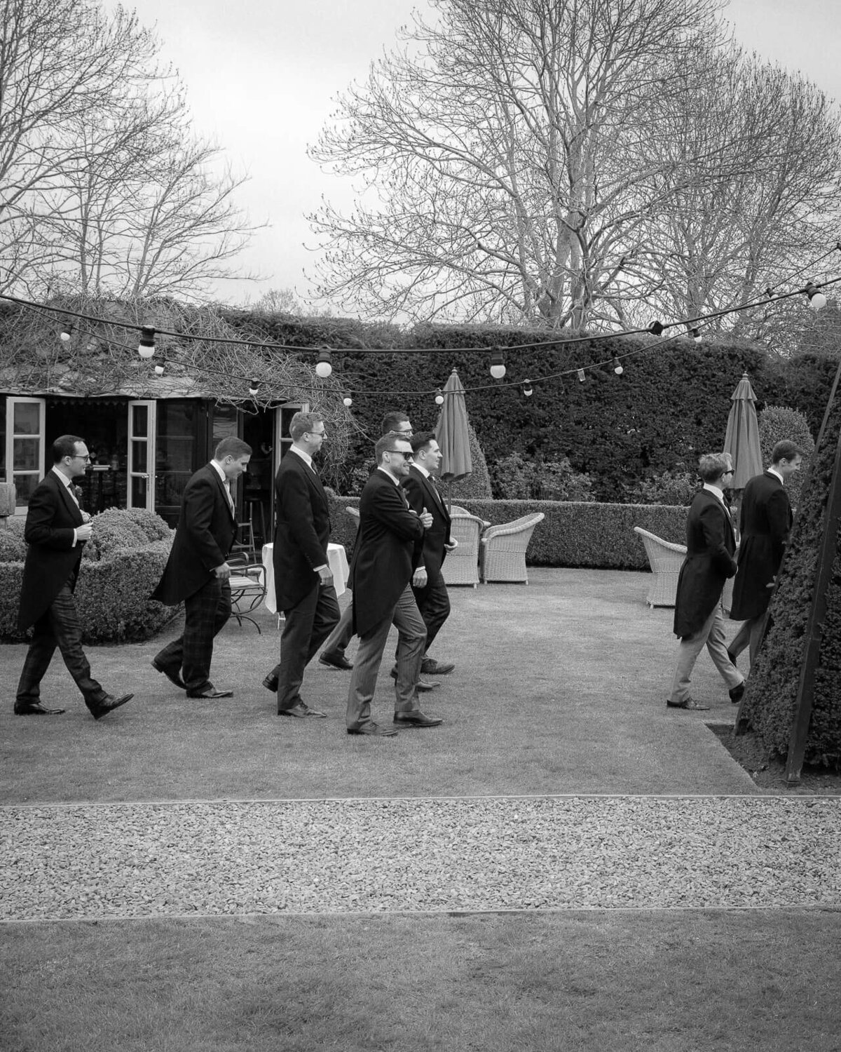 Groom and his groomsmen walk through the grounds of Prestonfield House