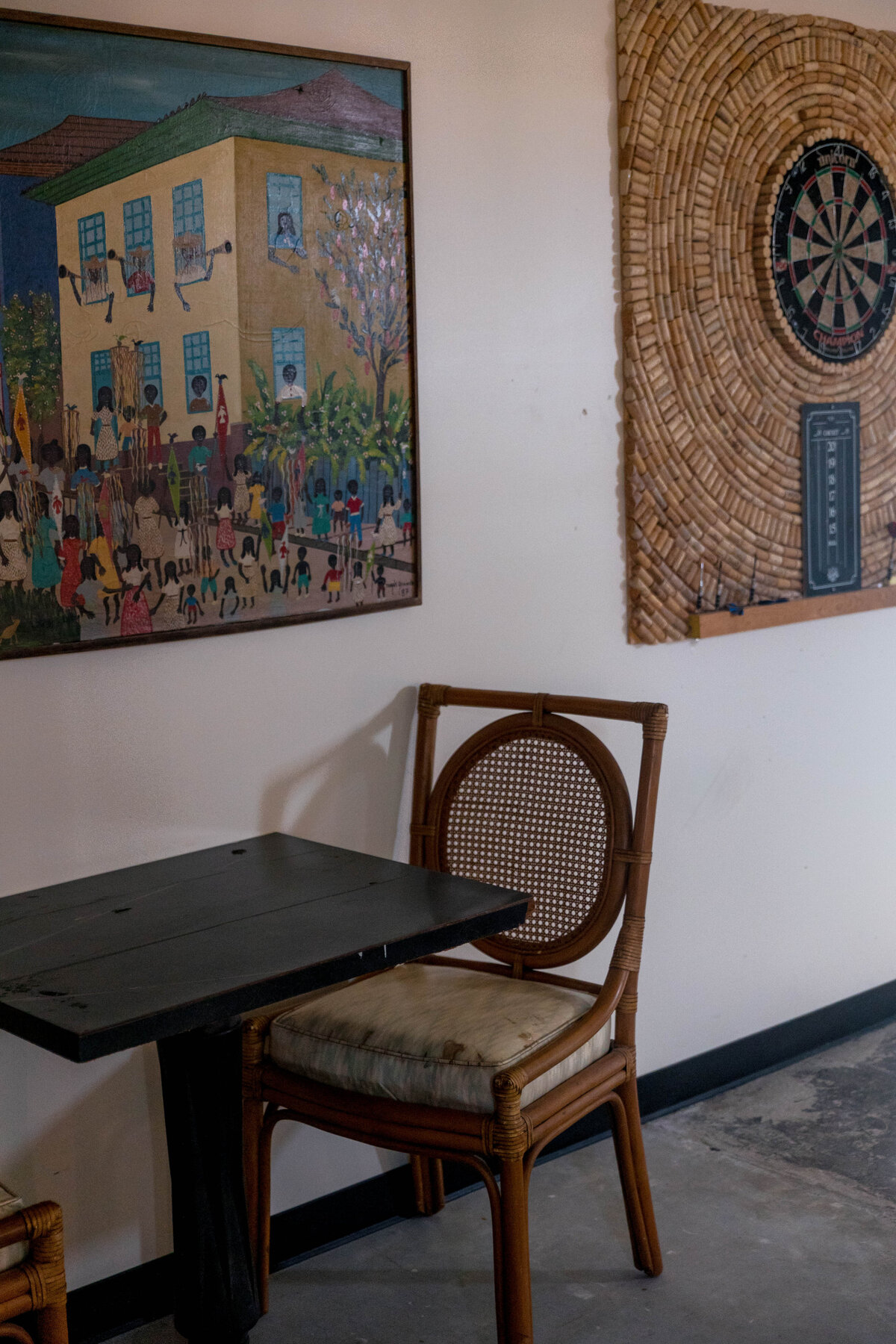 A chair and table with paintings behind it
