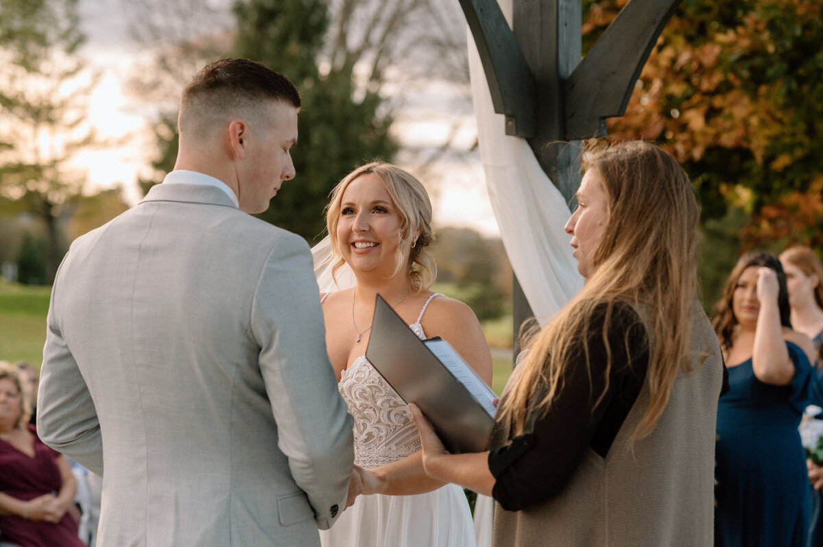 bride smiles at groom during vows