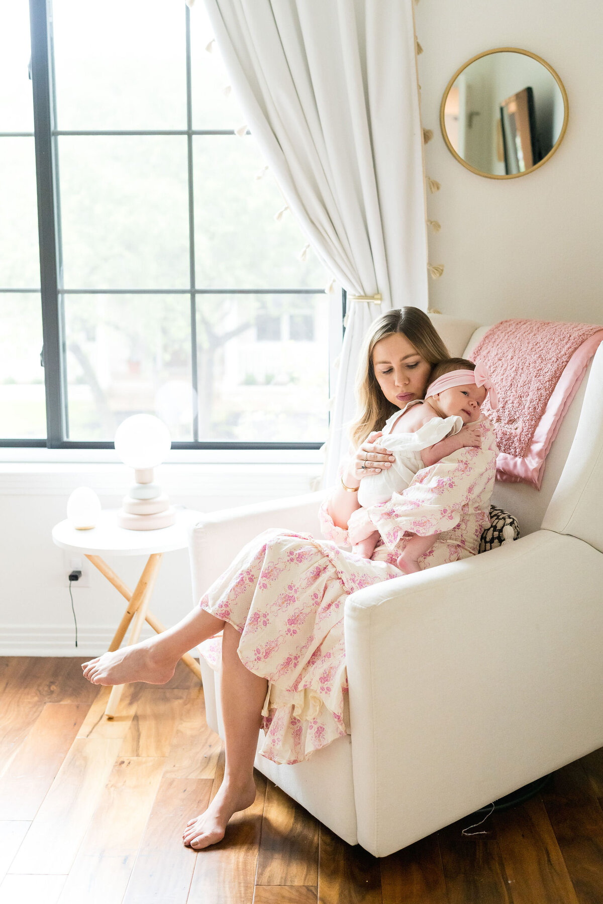 Natural light newborn session with family snuggled on the couch.