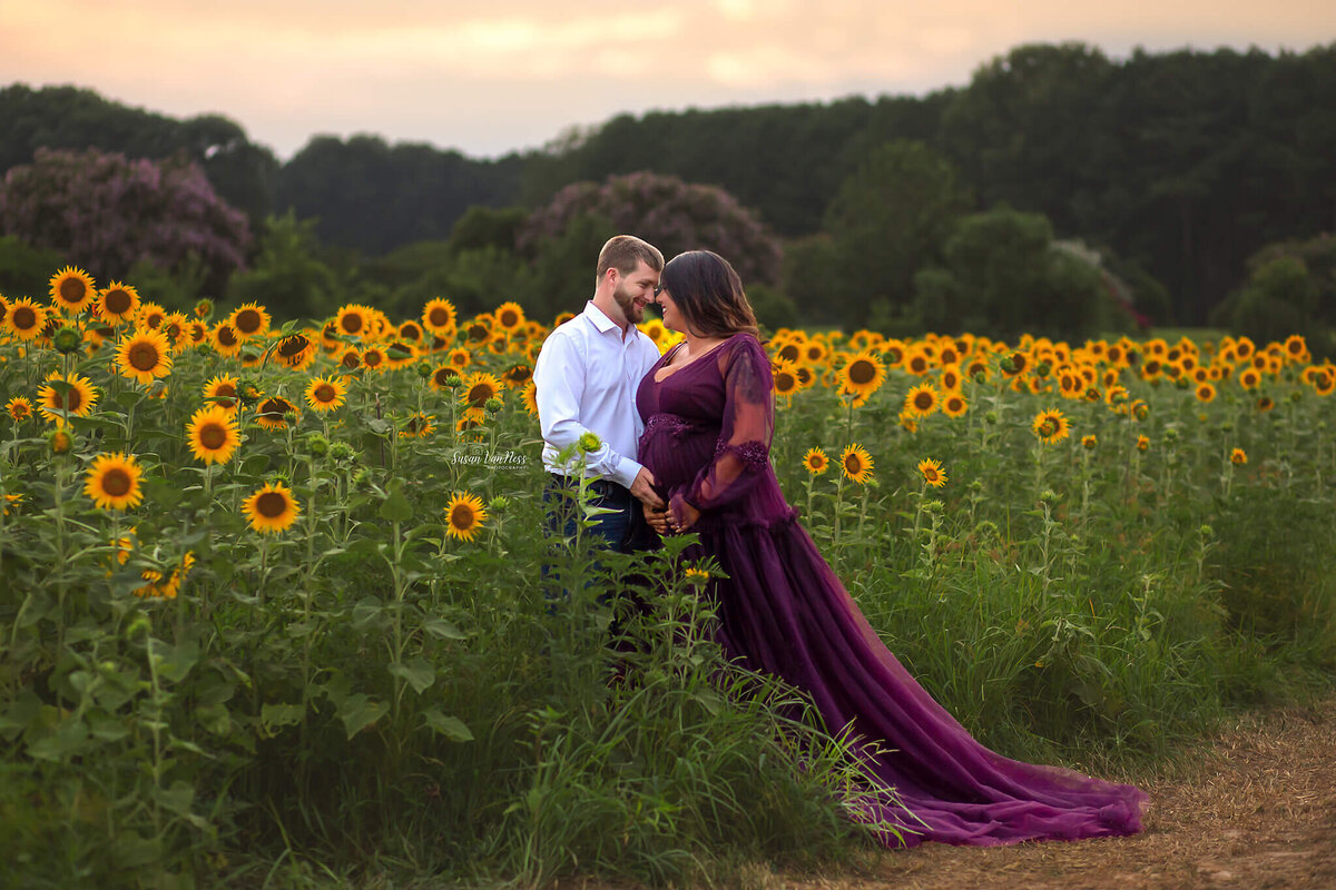 Expectant couple touching foreheads by Susan VanNess Photography, a Raleigh photographer