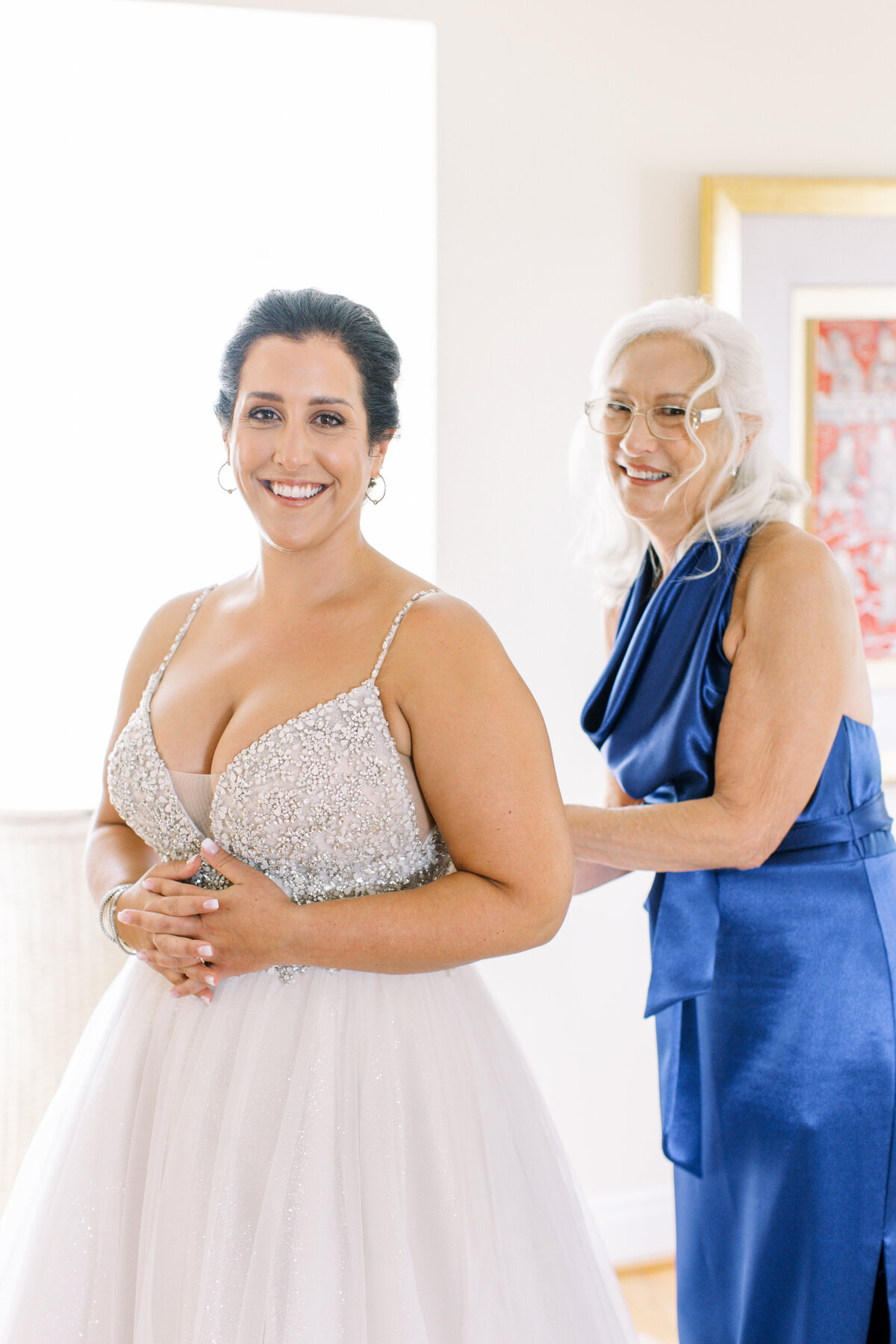 bride-getting-into-wedding-dress-at-ct-wedding