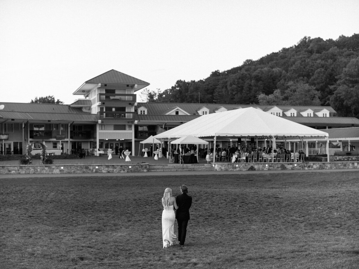 Wide view of tented outdoor wedding reception at Waynesville Inn and Golf Club in Waynesville, NC.
