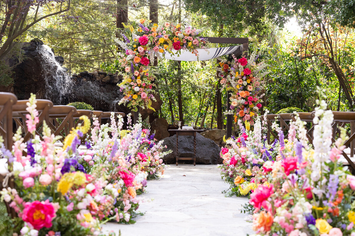 Brightly colored flowers lining an aisle