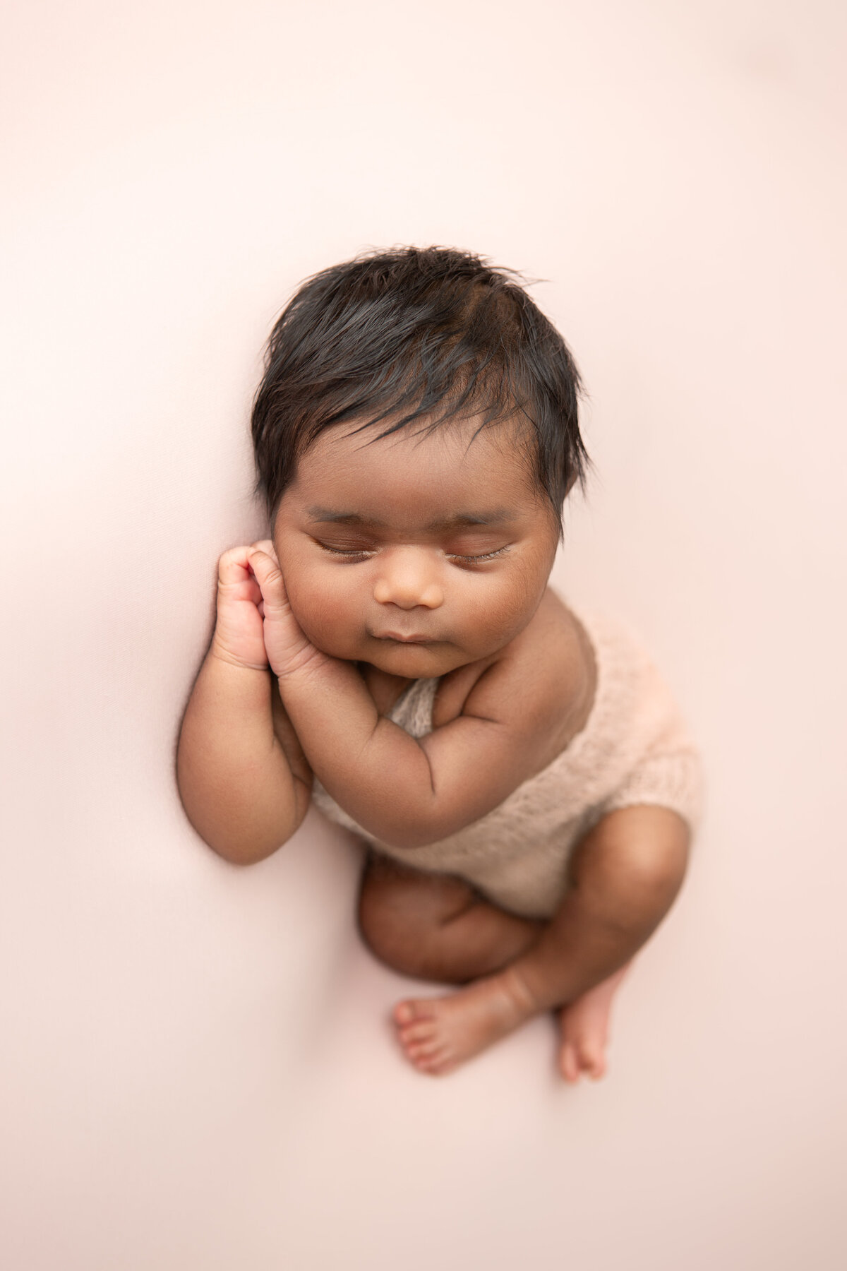 Pink newborn baby girl photography side laying table pose