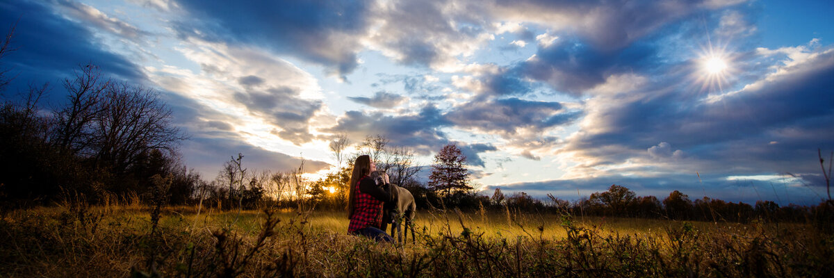 Woman and Great Dane Dog in Field at sunset