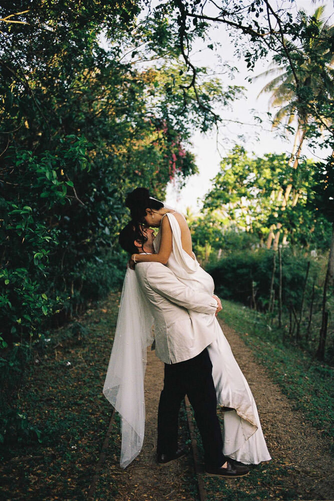 groom picking up bride at fiji intercontinental wedding on 35mm film