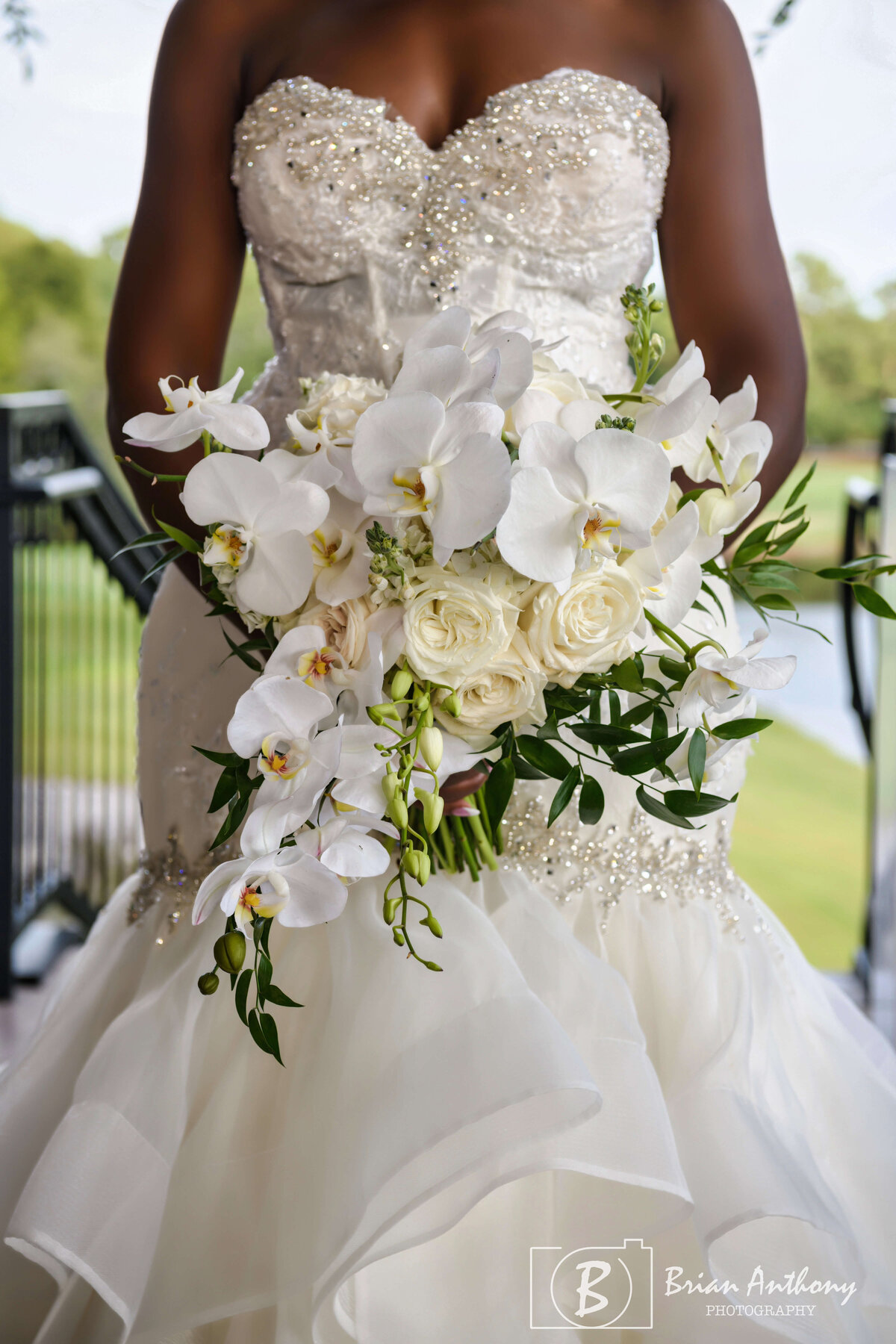 Elegant bridal bouquet featuring white roses and cascading greenery.