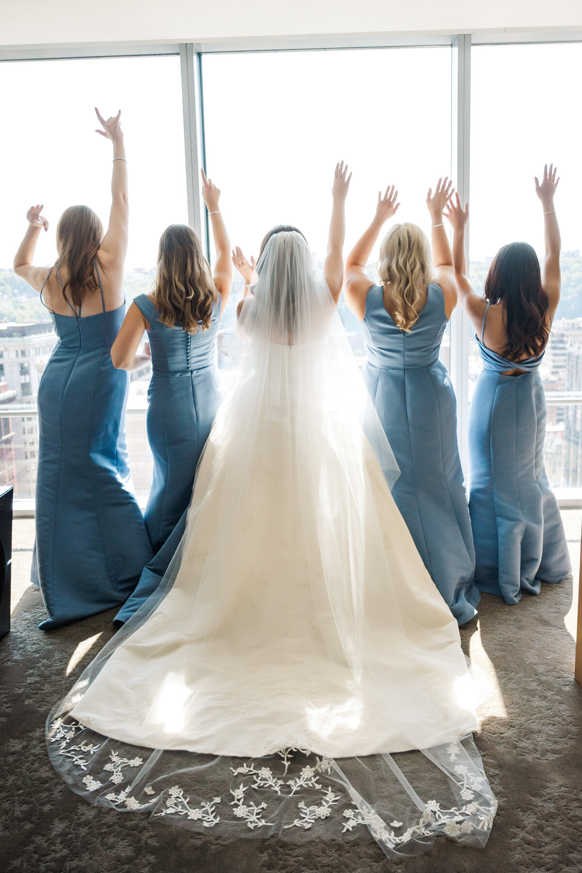 bridesmaids cheering for bride on her wedding day