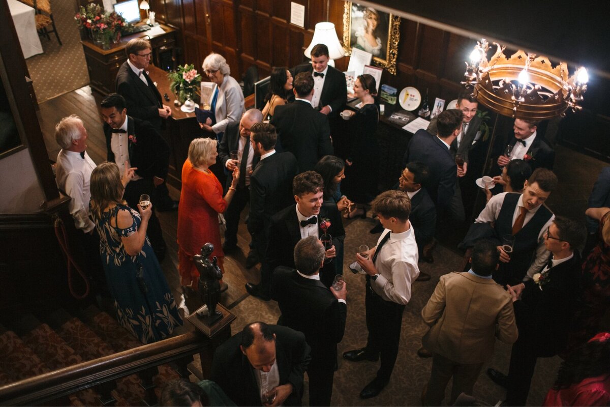Wedding reception guests mingle in lobby