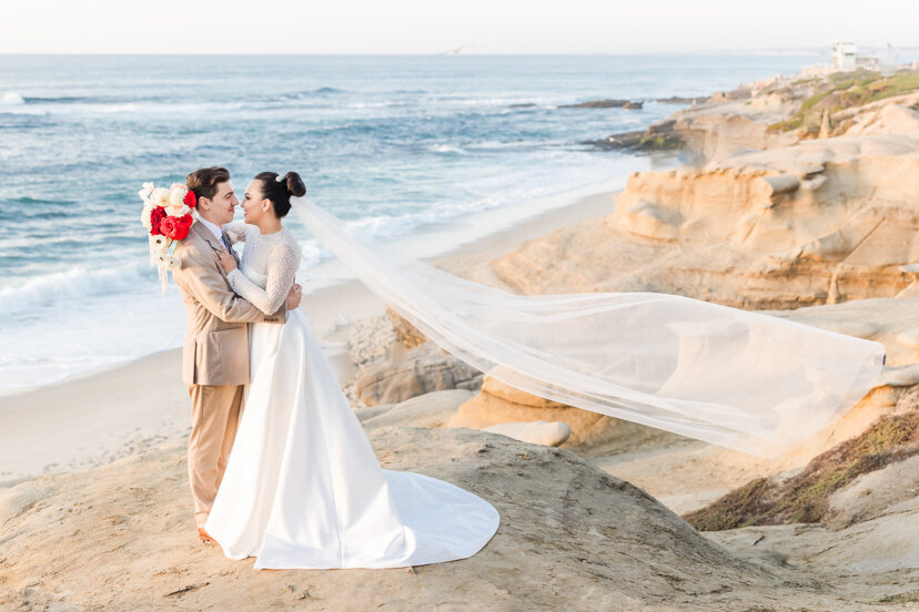bride-and-groom-on-la-jolla-cliffs-san-diego-with-flying-veil