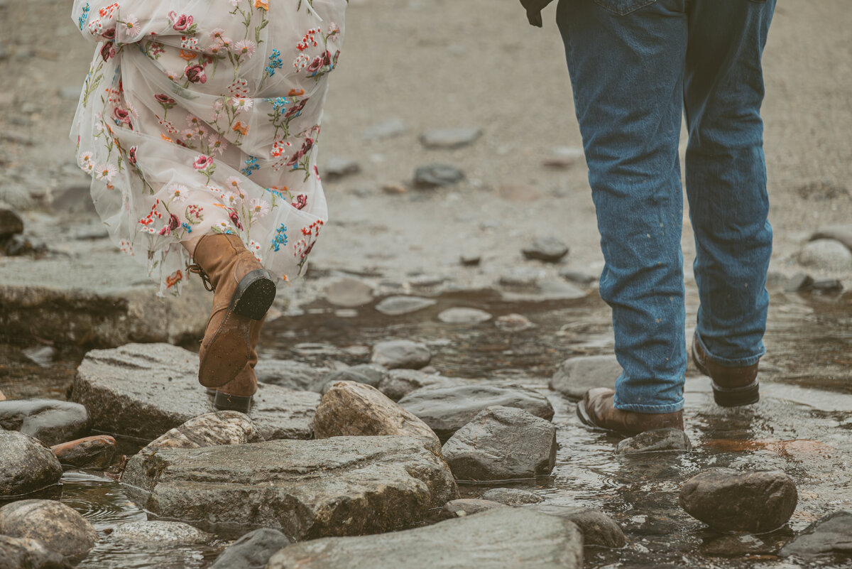 elopement couple hiking through the creek