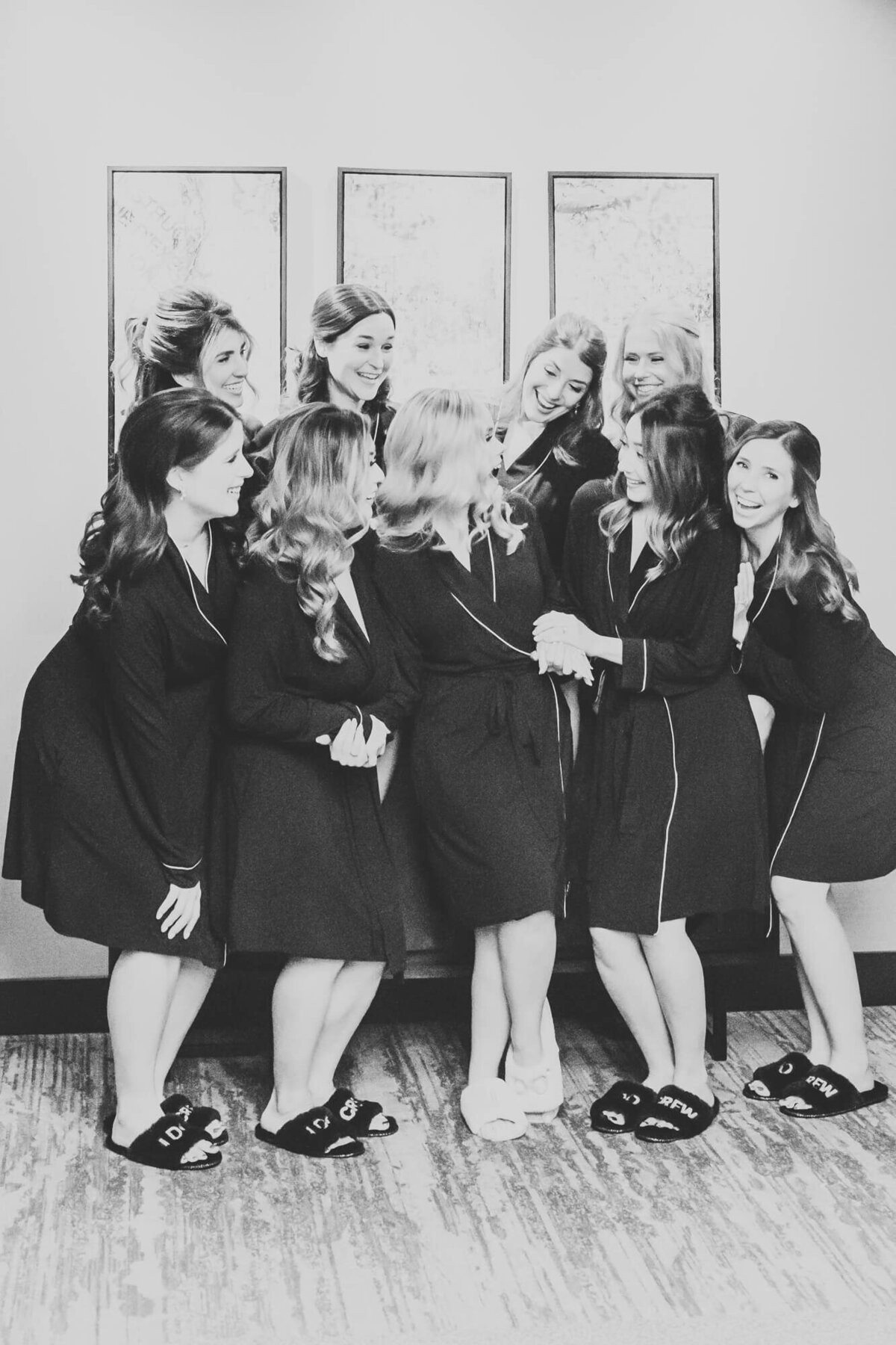 black and white image of bridesmaids doting on the bride before her nuptuals.