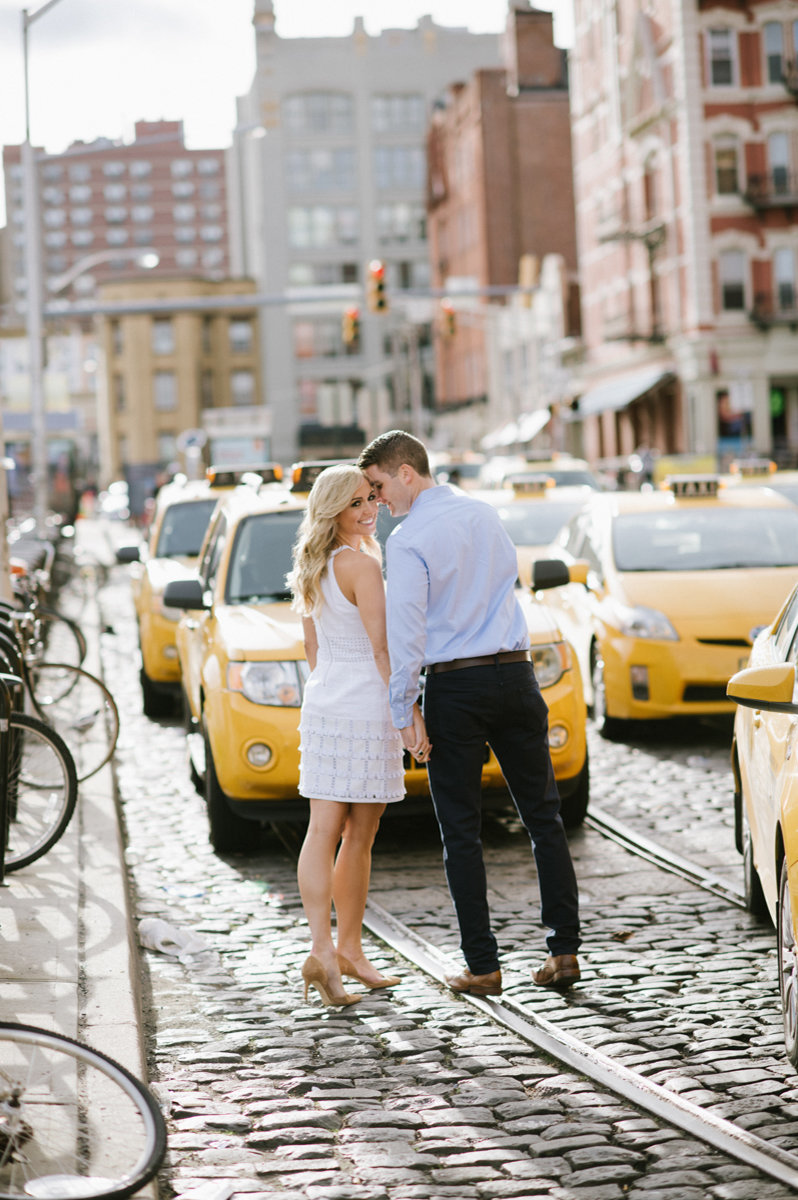 Couple walking through hoboken NJ near cabs
