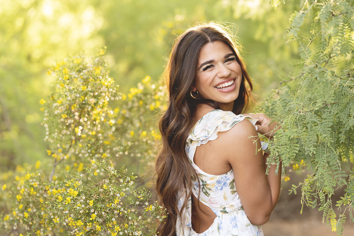 Scottsdale senior photographer yellow flowers girl smiling