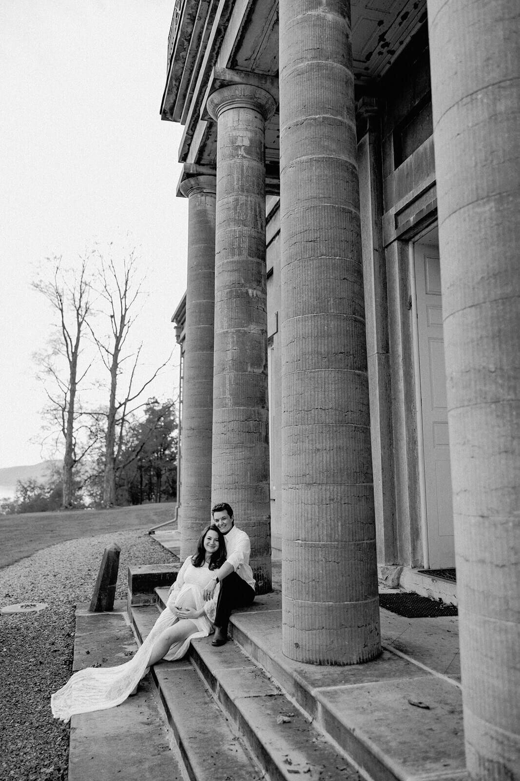 Couple outside historical building at Finger Lakes maternity session, NY
