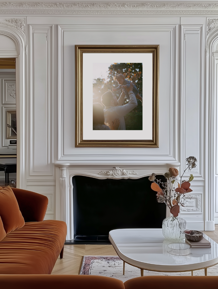 large framed print of family photo hanging above fireplace