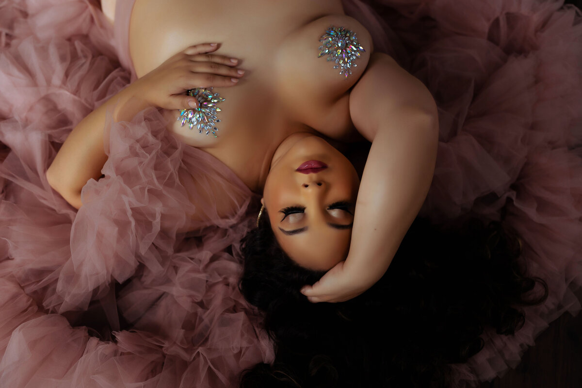 nude woman with crystal pasties wearing luxury tulle robe during boudoir session