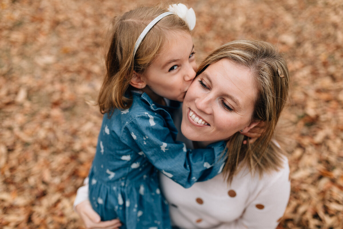 mum and daughter kissing in autumn leaves Melbourne outdoor family photographer And So I Don’t Forget Photography