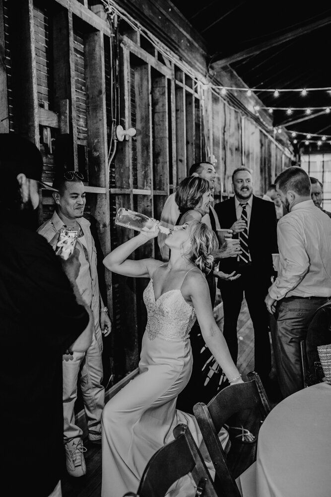 bride-celebrating-wedding-reception-teachout-building-des-moines-iowa-storyteller-collective-photo-co