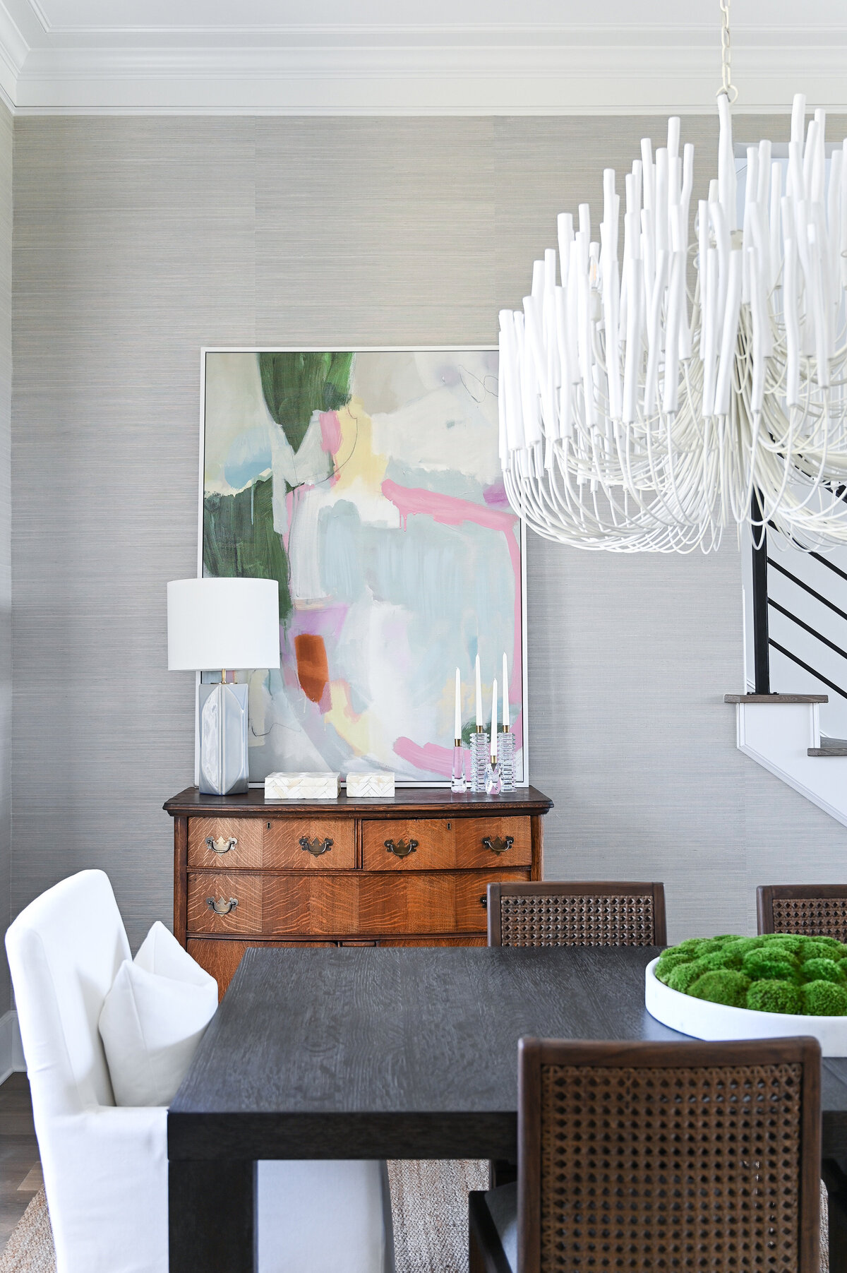 dining room with large chandelier and abstract artwork on wall