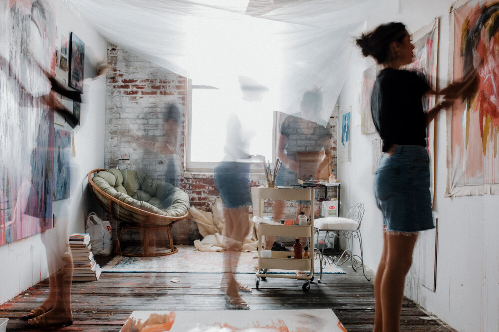 an artist working in her paint studio