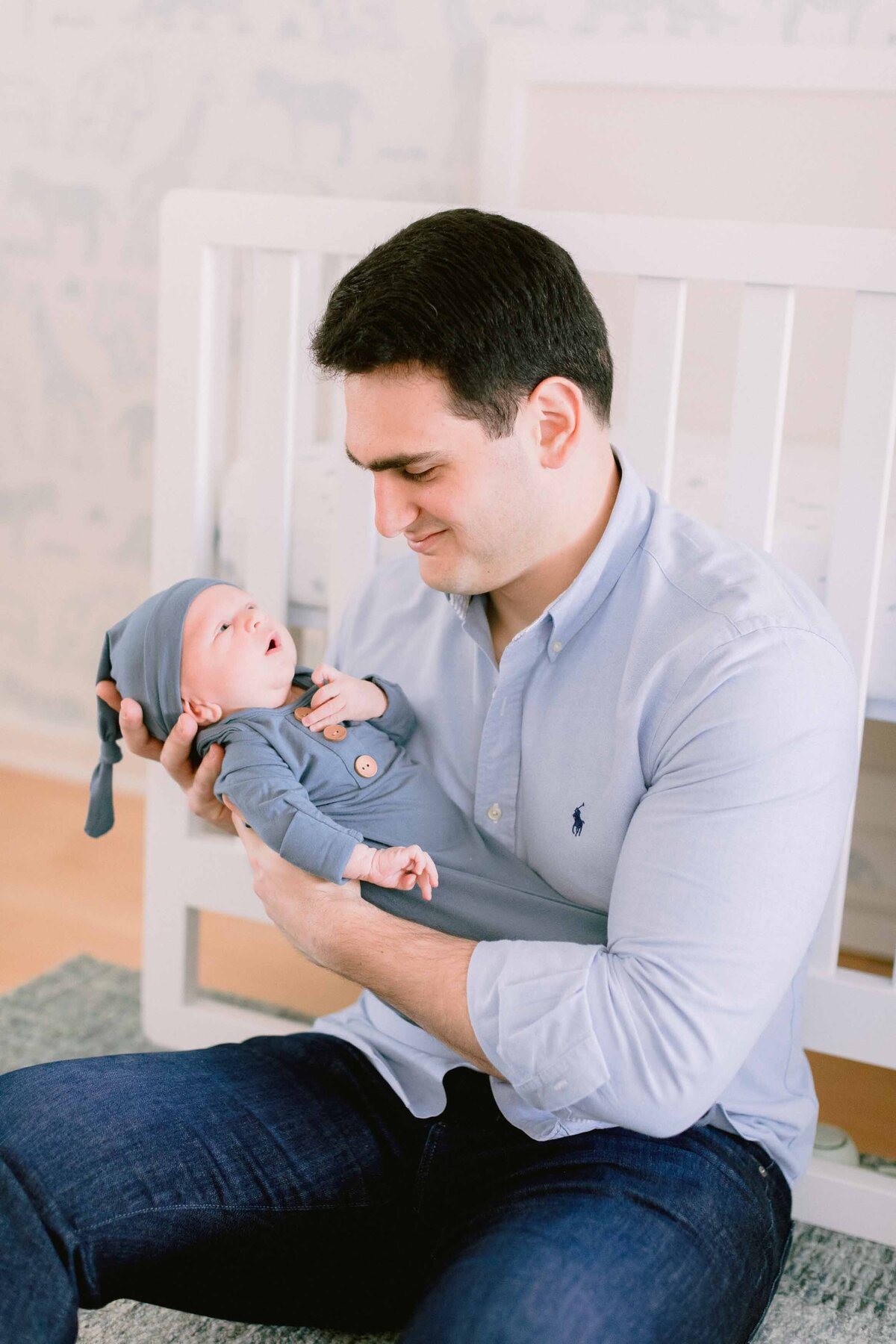 dad looking at his newborn son