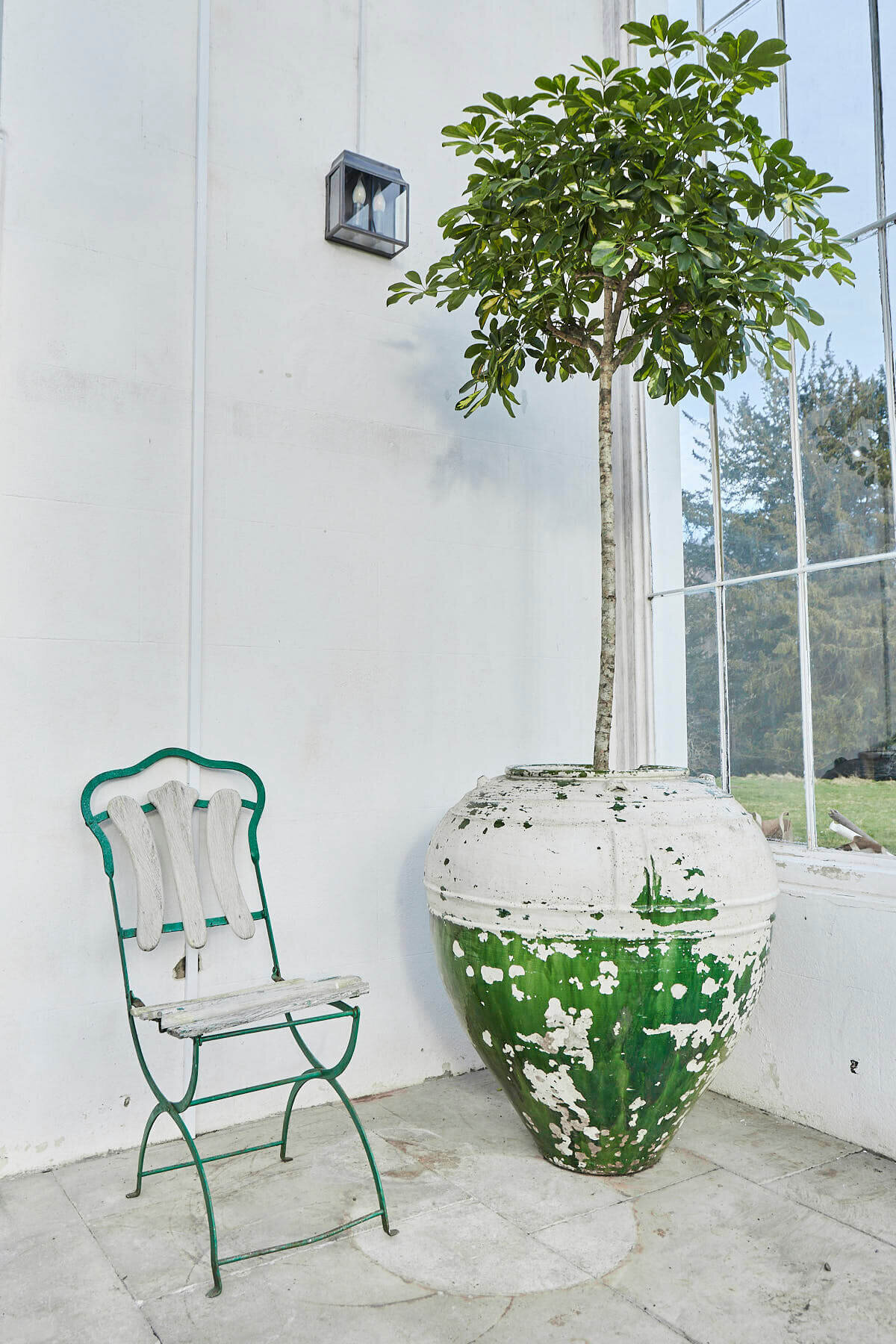 A chair sitting next to a tree