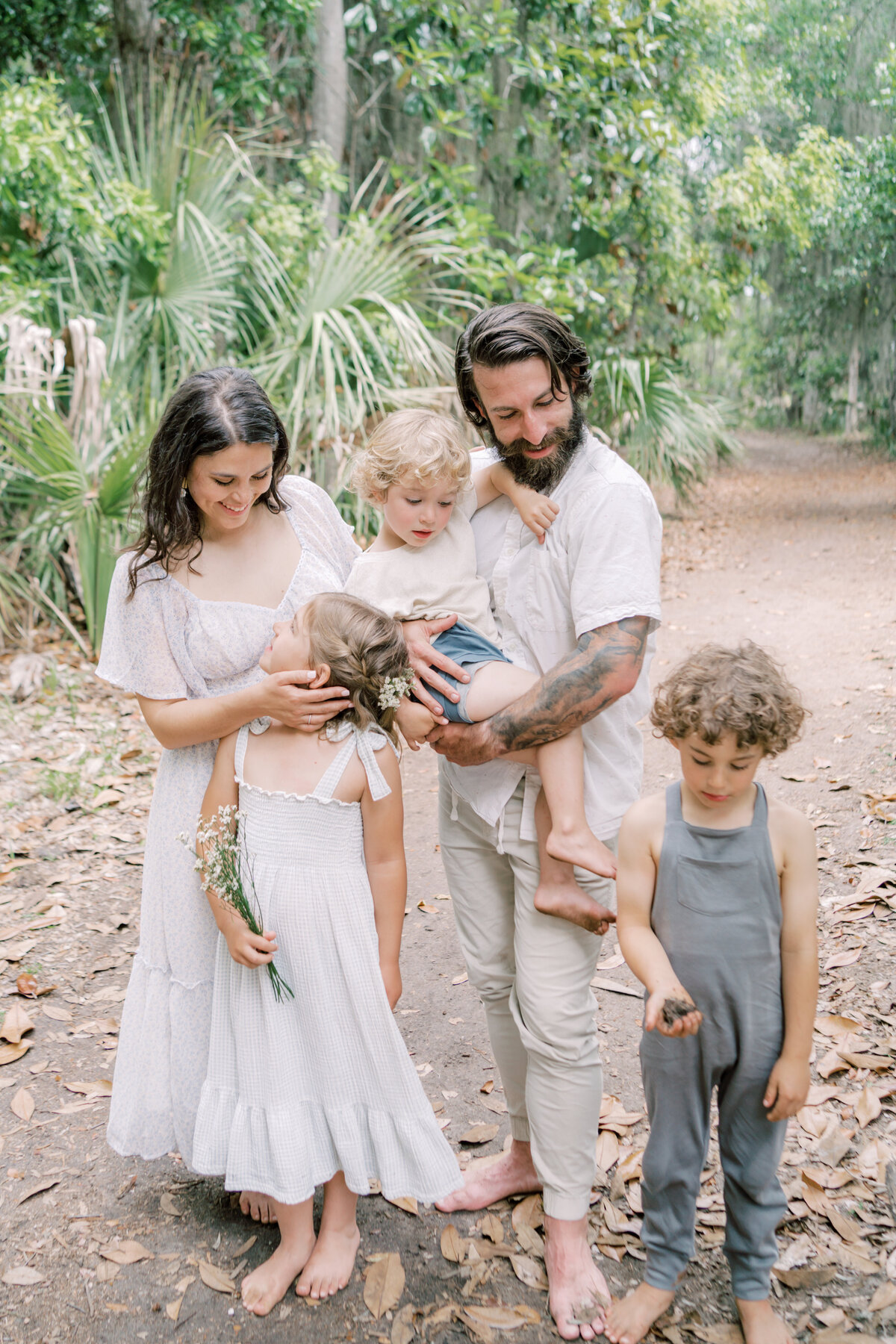 Family Portrait of a family of five standing on a pathway at Wormsloe Historic Site by Savannah  Family photographer Courtney Cronin