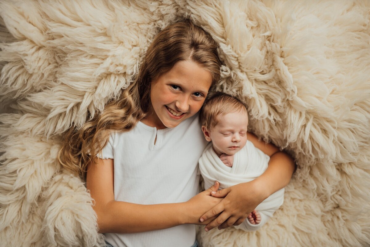 sister and new baby in studio in Tampa