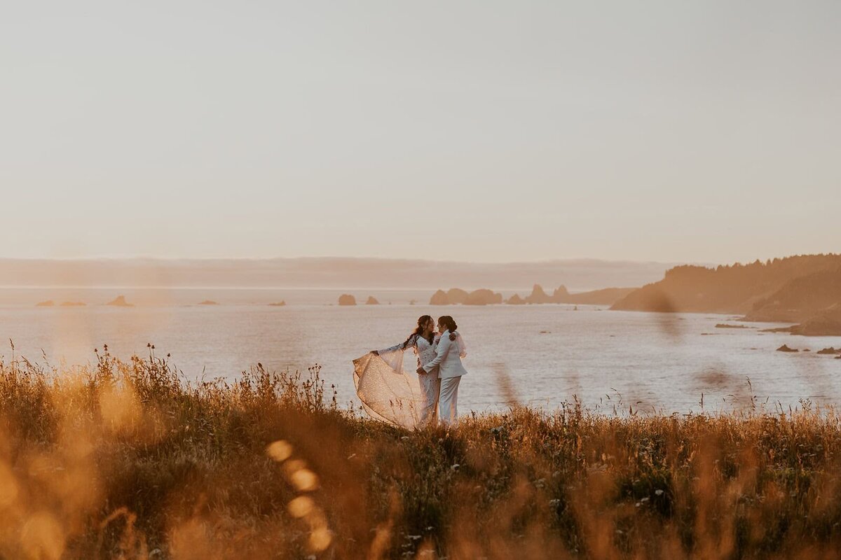 Couple standing on a cliff on the Oregon Coast during their elopement