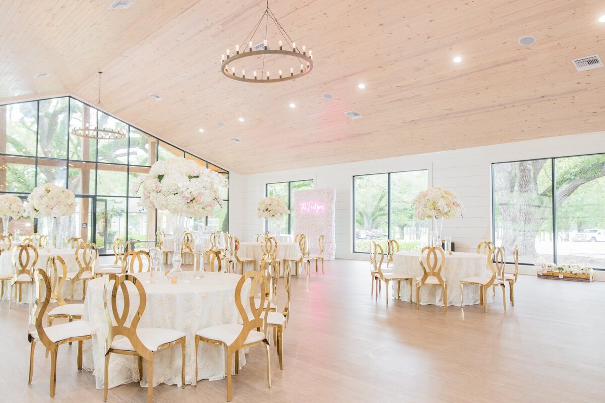 wedding reception decorated with a pink, white, and gold theme
