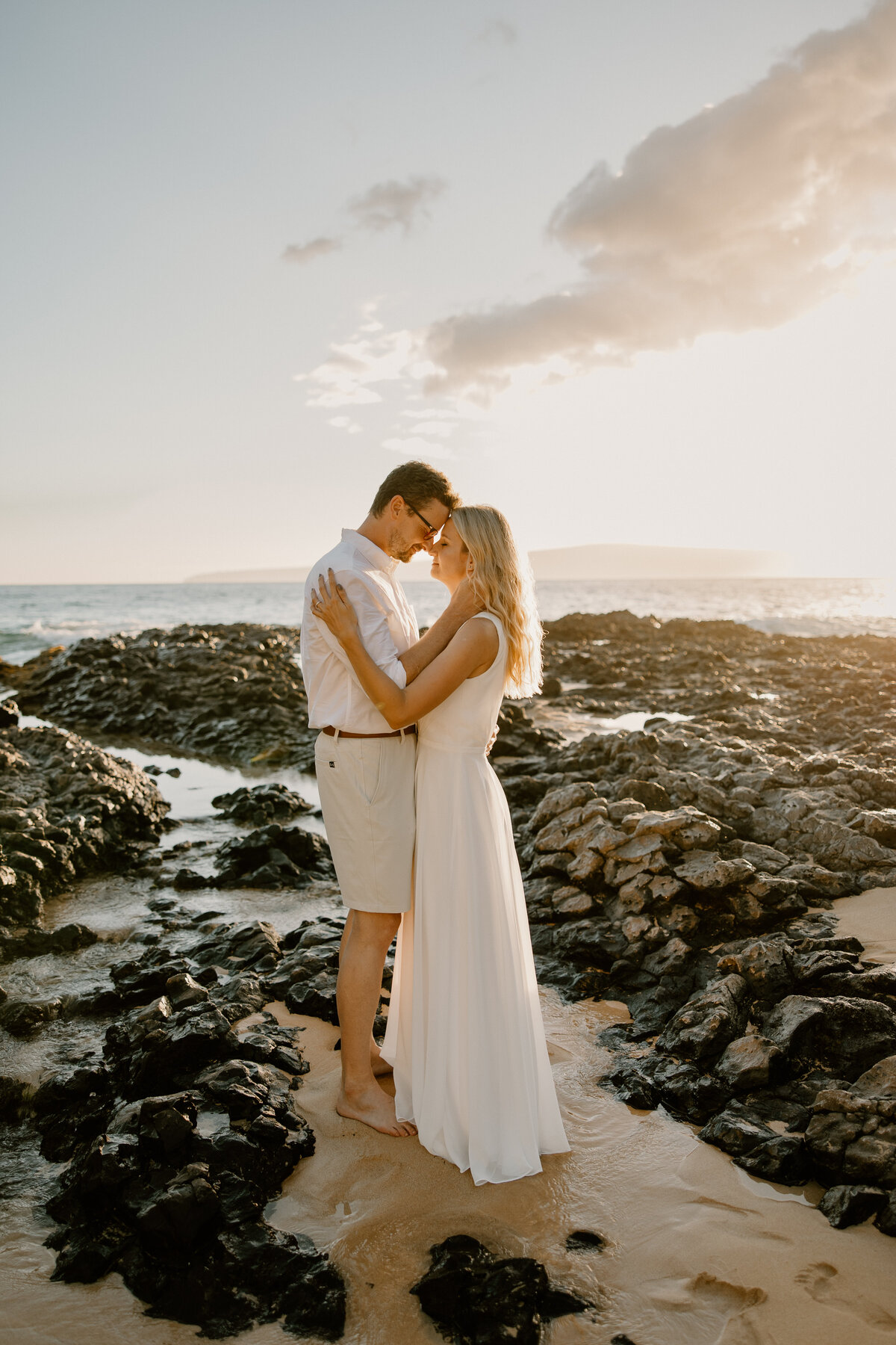 Maui Wedding Photographer captures bride and groom hugging on beach after Maui beach wedding