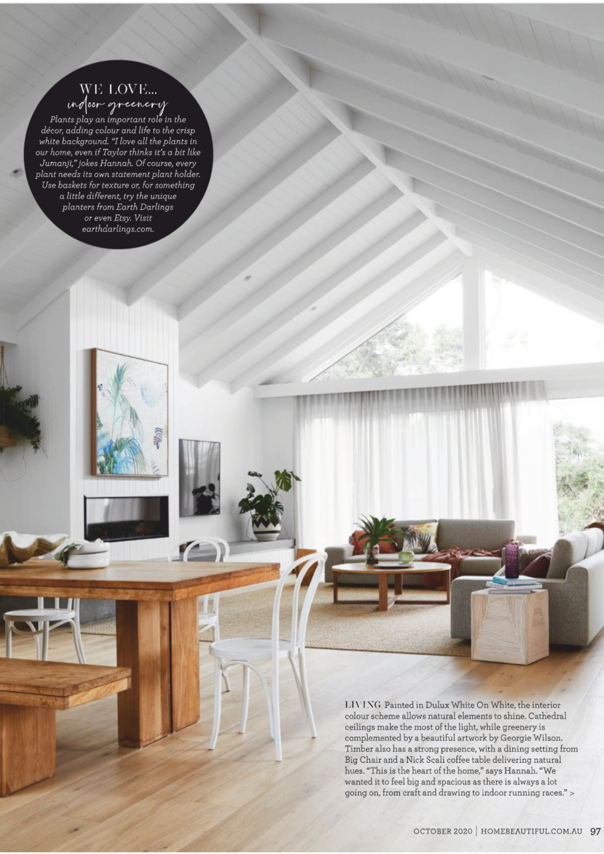 Stylish living room design with green artwork featured in magazine spread