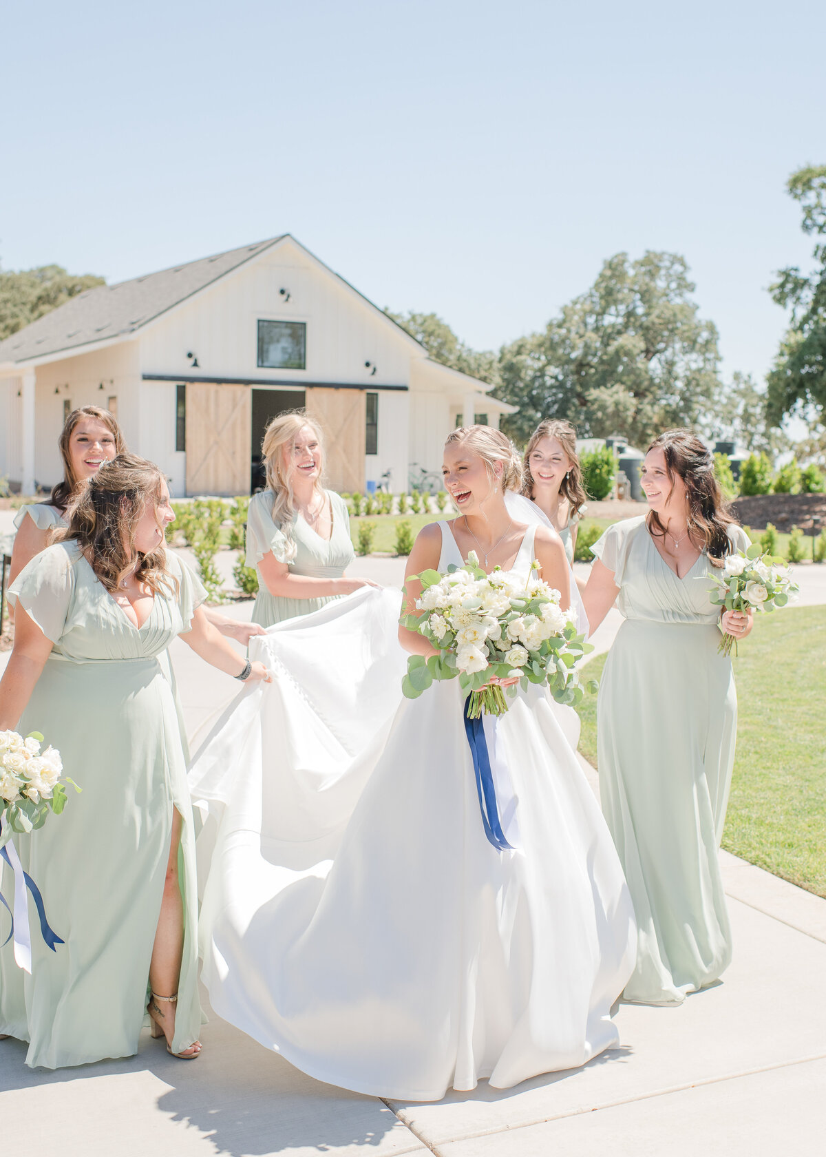 bride walking with her ladies in front of their wedding venue