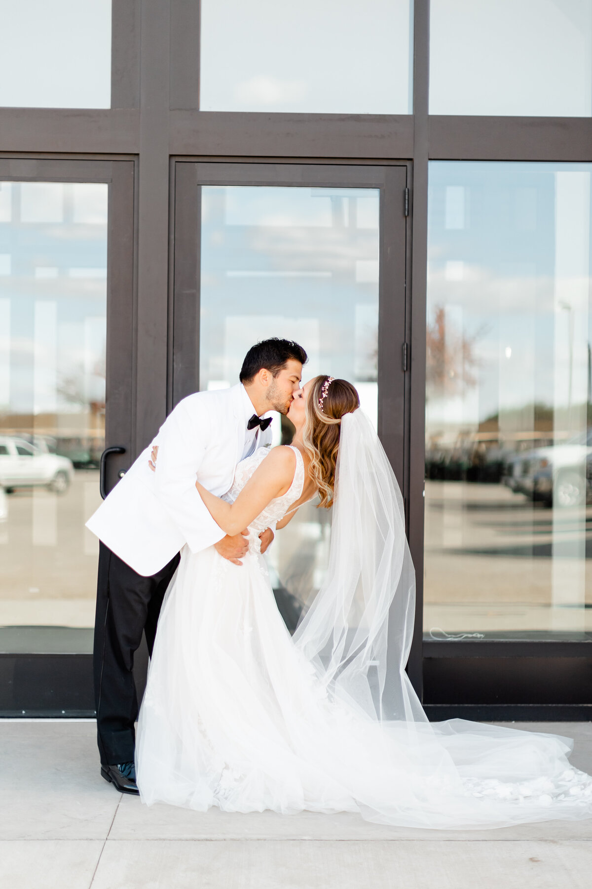 couple in front of doors kissing by one of the wedding photographers orlando