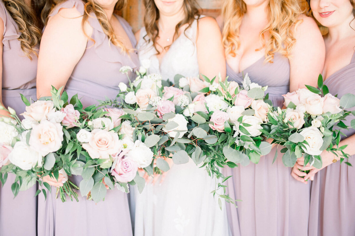 close up of bouquets being held by bridesmaids and bride