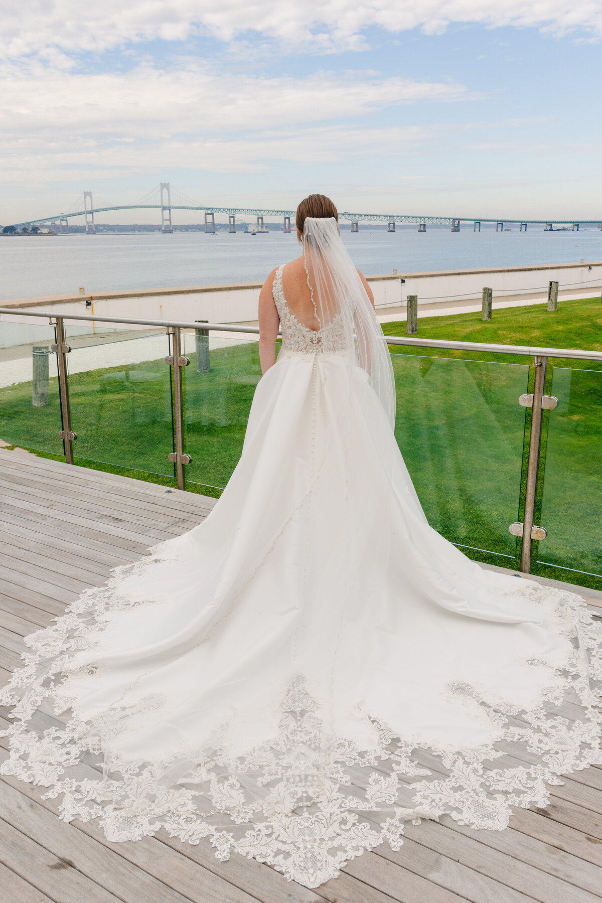 wedding gown in front of Newport Pell Bridge