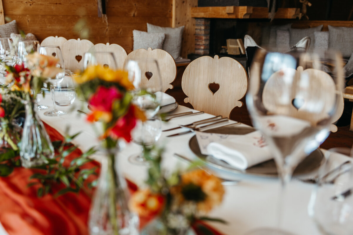Elegant dinner table setup with red and gold accents Dolomites wedding