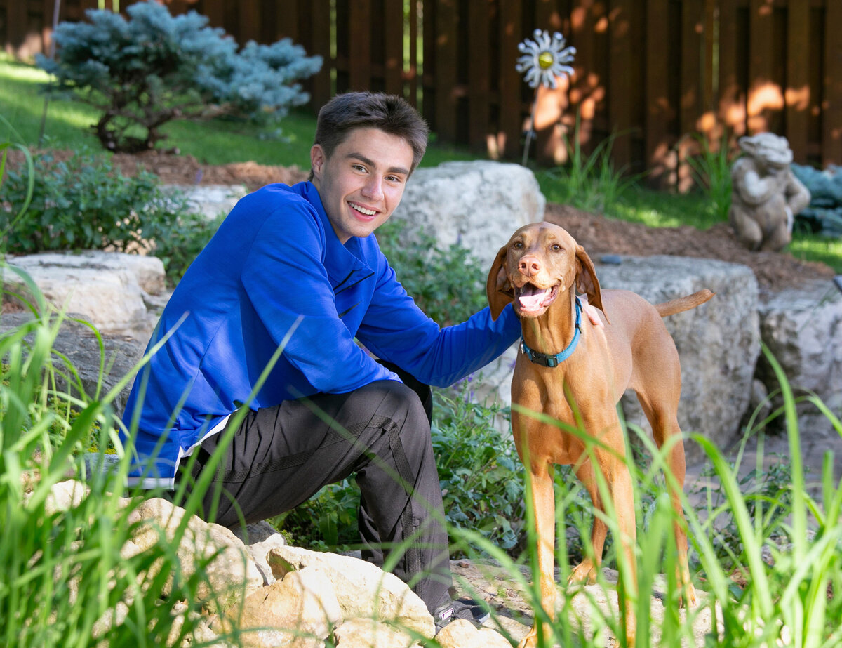custom location senior pictures at home in backyard with dog