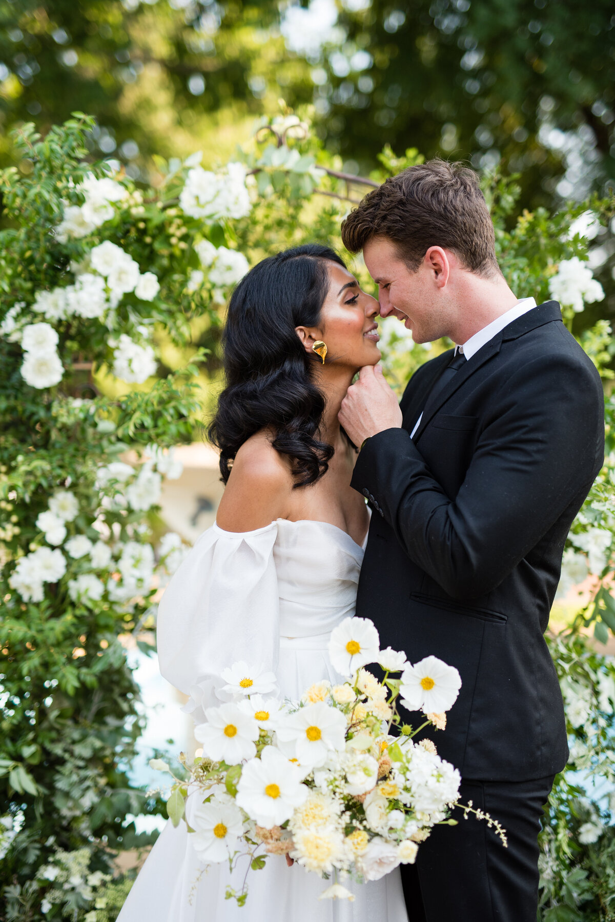 Bride and groom embrace as they go in for a kiss during golden hour at Lairmont Mansion in Bellingham, Washington.